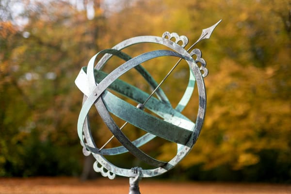 elegant sundial against autumn foliage