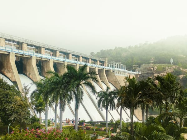 majestic dam with lush greenery and waterfall